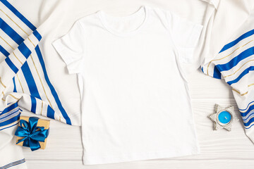 Jewish holiday Hanukkah white t-shirt mockup with gift box and candles, Top view from above on...