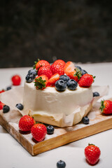 Confectionery on white background, strawberry blueberry cake