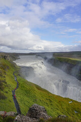 Southwest Iceland: Visitors walk along a trail as mist rises from Gullfoss (Golden Falls), the most famous waterfall in Iceland.