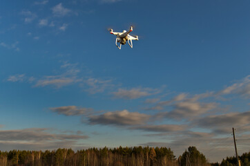 Fototapeta na wymiar Professional quadcopter with high resolution camera onboard doing its job