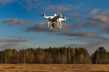 Professional quadcopter with high resolution camera onboard doing its job - Powered by Adobe