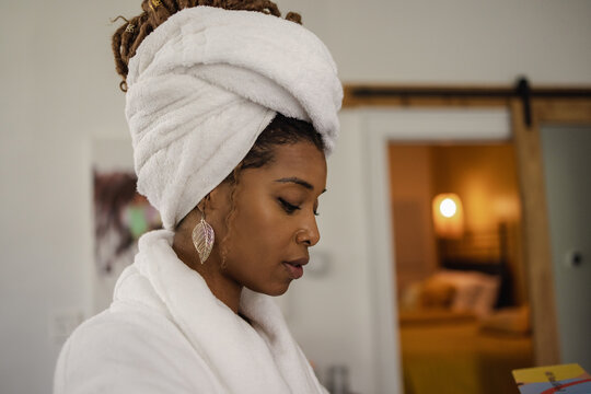 Woman in bathrobe and towel wrapped around head
