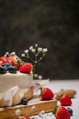 Beautiful strawberry cake decorated with blueberries on a white background