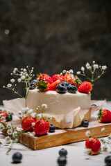 Beautiful strawberry cake decorated with blueberries on a white background