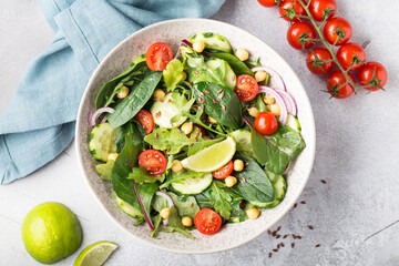 vegetarian chickpea salad with tomatoes, cucumber, red onion, arugula. vegetarian protein and fiber.Top view