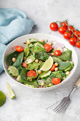 vegetarian chickpea salad with tomatoes, cucumber, red onion, arugula. vegetarian protein and fiber.