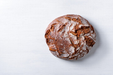 Freshly baked traditional country style wheat rye wholemeal bread. Single object on a white...