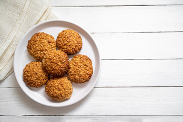 Homemade oat cookies in a plate, healthy dessert, bright background