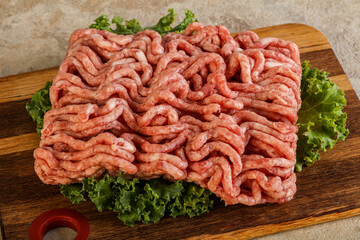 Raw pork minced meat over board