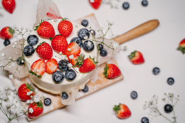 Beautiful strawberry cake decorated with strawberries and blueberries
