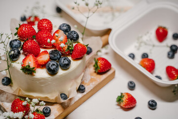 Bento cake with berries in a white package - container