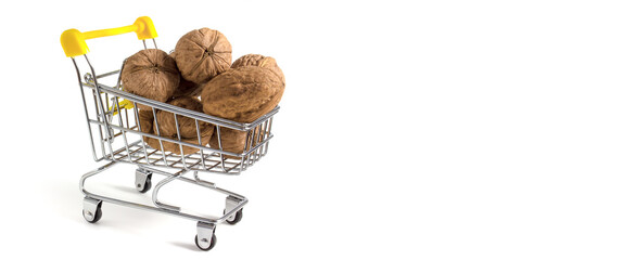 Shopping cart with walnuts isolated on white background with place for copy-space © malshak_off