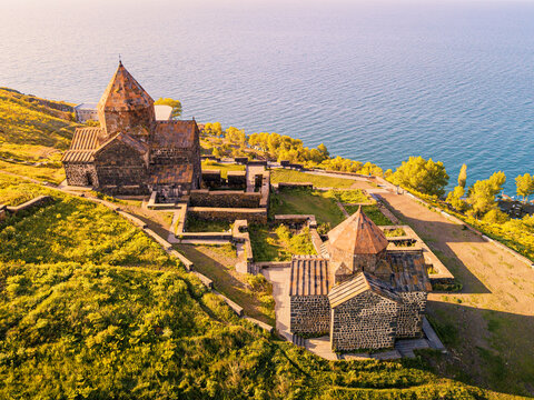 Drone point of view to Sevanavank Monastery and chapel overlooking famous Sevan lake at sunny spring day. Travel and tourist destinations of Armenia