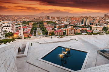 Scenic evening view from the stairs of Cascade monument to the colorful sunset over rooftops of Yerevan city and symbol of Armenia - Mount Ararat © EdNurg