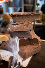 A pyramid of uneven chocolate pieces for sale in the market