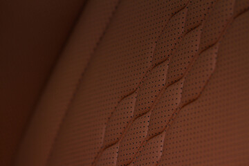 High angle view of modern car fabric seats. Close-up car seat texture and interior details. Detailed image of a car pleats stitch work. Leather seats.