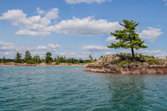 pine tree lined rugged rocky coast of Georgian Bay near the western enterance to Collins Inlet in Killarney, Ontario, Canada