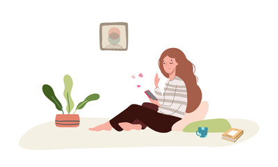 Smiling young woman looks into a mobile phone in the room