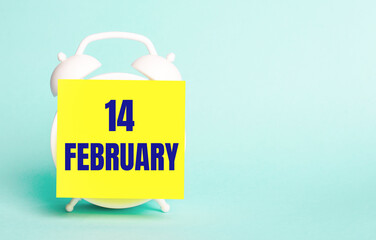 On a blue background - a white alarm clock with a yellow sticker for notes with the text FEBRUARY 14
