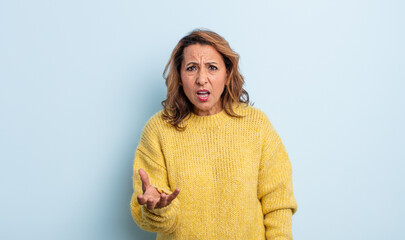 middle age woman looking angry, annoyed and frustrated screaming wtf or what’s wrong with you