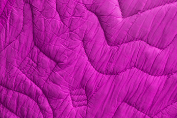 red large bedspread. pink unusual texture. magenta rippled background. purple embossed surface