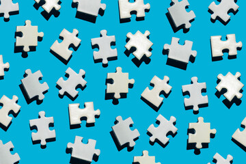 many puzzle pieces on a blue background