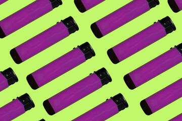 purple cigarette lighters on a green background. smoking concept