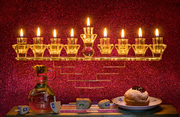 Image depicts Jewish holiday Hanukkah with menorah and burning candles, jar with olive oil, sweet...