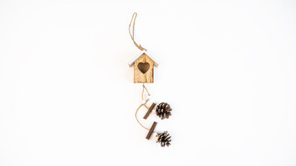 Beautiful wooden in shape of house with pinecone and heart, copy space for text