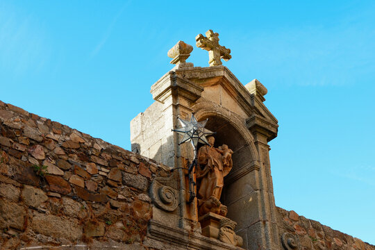 Church wall with a statue of the virgin mary and a star-shaped lamp in Caseres, Extremadura, Spain