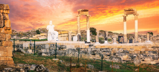 Ancient city of Hierapolis with statue of Pluto in Pamukkale under dramatic sky