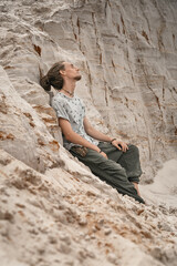 person sitting on sand