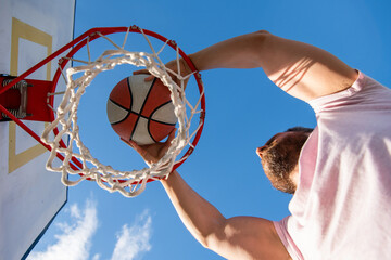 professional basketball player training outdoor. guy has sport motivation. sport and hobby © Olena