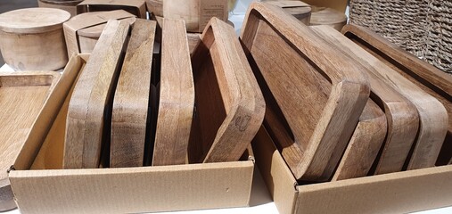 Soap dishes made of natural wood for the bathroom. Eco-friendly bathroom decor. Stylish new soap dishes in the store. Rectangular wooden coasters for home decor.