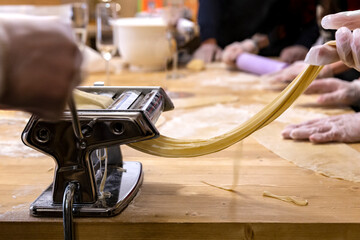 Cooking homemade Italian pasta spaghetti using a pasta maker machine