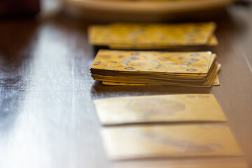 Yellow playing cards lying on the table. - Powered by Adobe