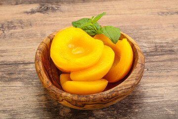 Sweet ripe canned peaches with mint