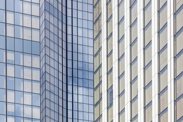 Glass facade of a new skyscraper. Endless rows of panoramic windows. Panoramic glazing of high-rise buildings. Lots of windows. Exterior of a modern city. Background, backdrop or texture
