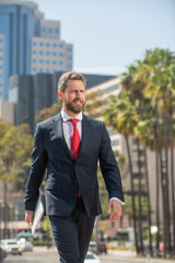 businessperson walk outside the office. freelance man holding pc. businessman using laptop