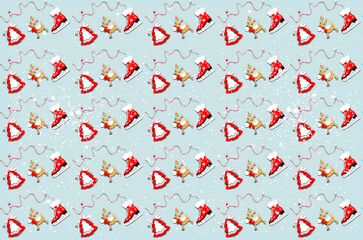 Pattern of Christmas wooden figurines on gray background. Festive concept for gift wrapping paper design.