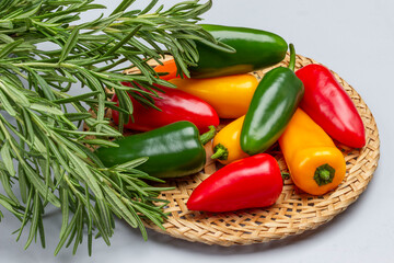 Multi-colored peppers in wicker plate.