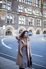 Pretty woman with curly hair in old town