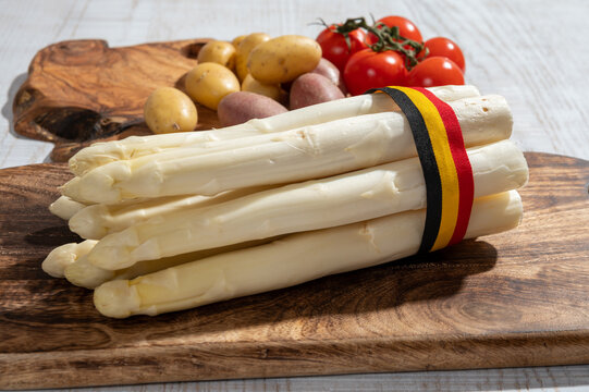 New harvest of high quality Belgian white asparagus washed, uncooked, tasty vegetarian dinner