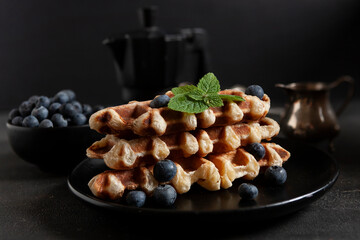 Сroffle, trendy crispy korean baked goods, top view on dark background, selective focus