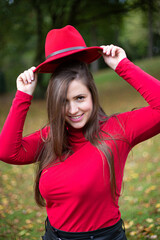 Smiling white young european woman in red in fall