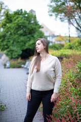 Fototapeta premium White european woman in white sweater in park