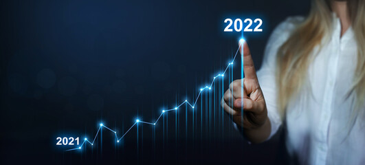 Business plan for increase in 2022 year.Business person draws increase arrow graph corporate future...