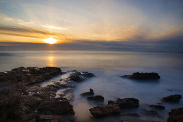 Fototapeta na wymiar Sunrise with the rough sea on the Costa Azahar