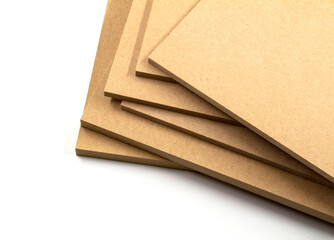 Raw mdf boards piled up, ready to paint.