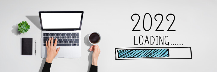 Loading new year 2022 with person using a laptop computer - obrazy, fototapety, plakaty